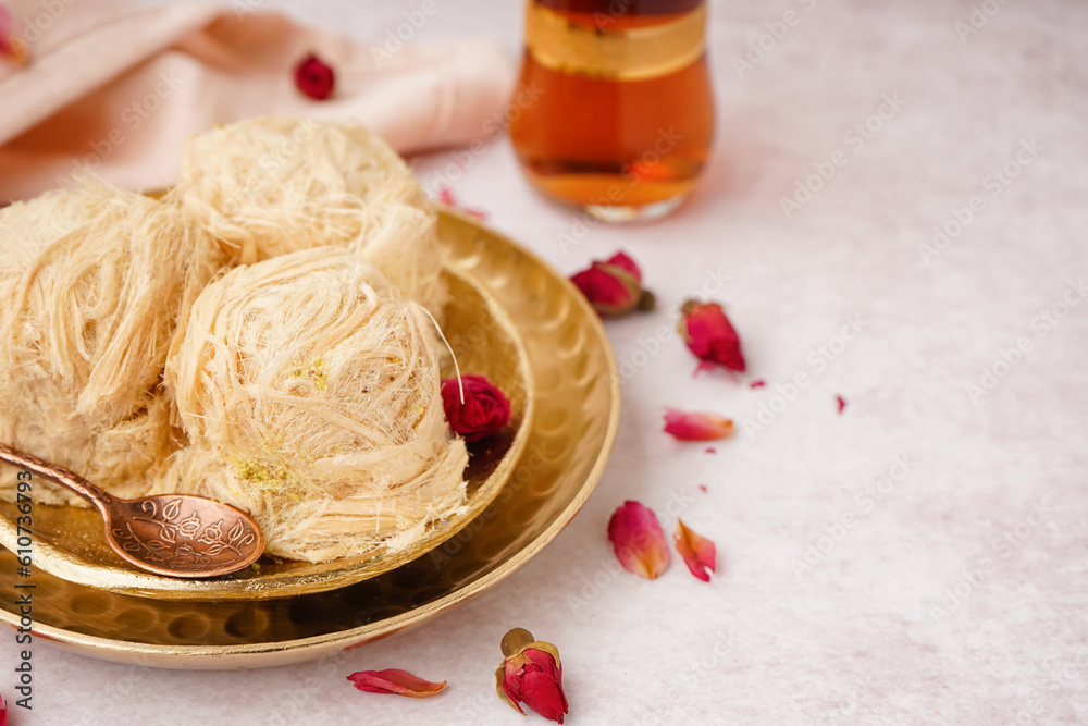 Plates with tasty Turkish Pismaniye on light background, closeup