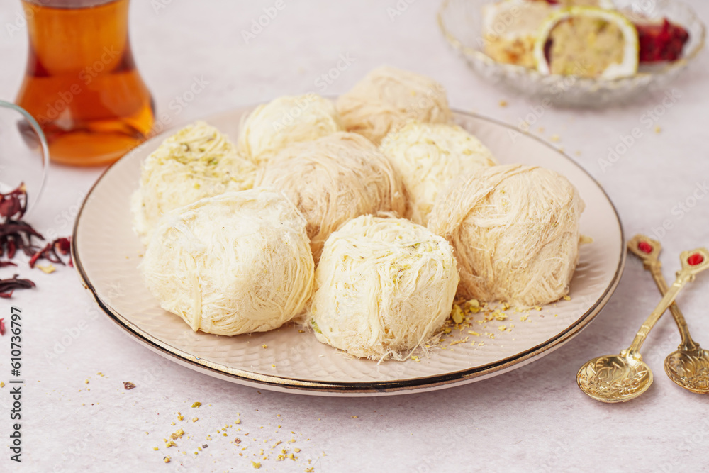 Plate with tasty Turkish Pismaniye on light background