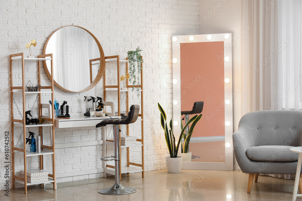 Interior of beauty salon with hairdressing table and mirrors