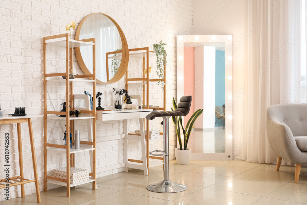 Interior of beauty salon with hairdressing table and mirrors