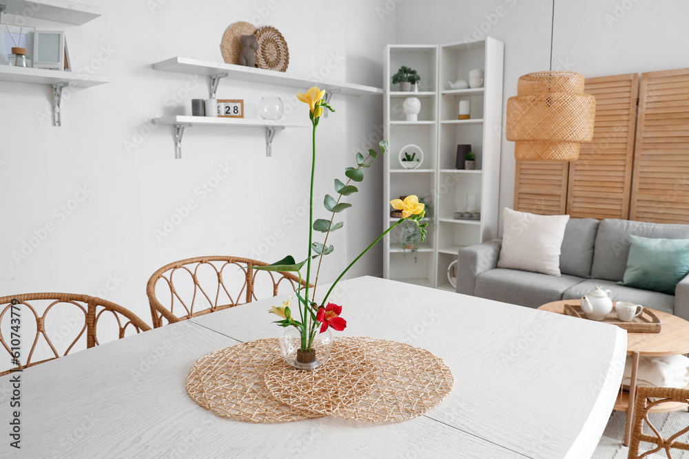 Beautiful ikebana on dining table in room