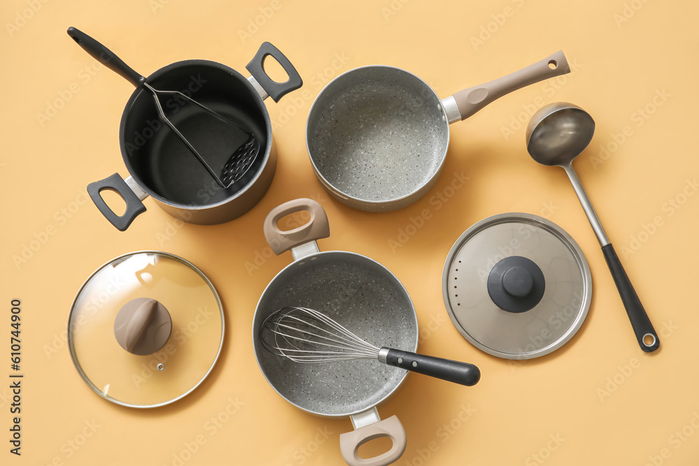 Set of kitchen utensils on beige background