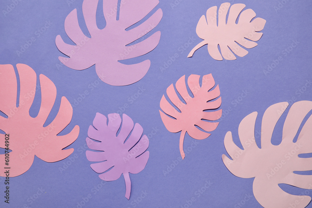 Beautiful origami leaves on purple background