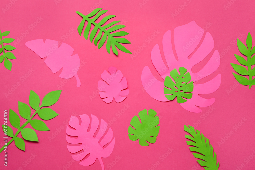 Beautiful origami leaves on pink background