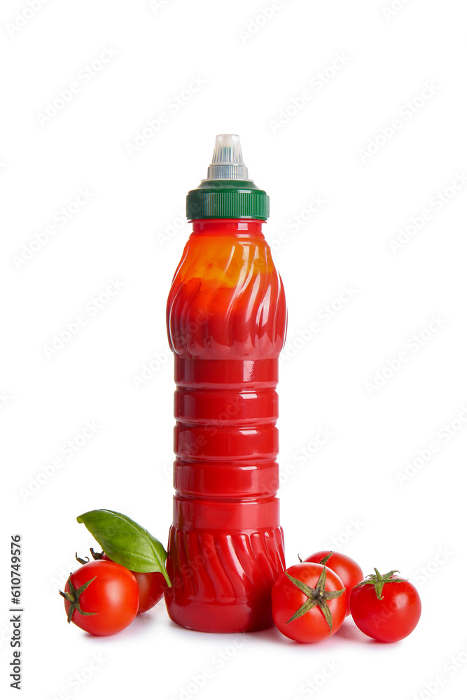 Bottle of ketchup and tomatoes on white background