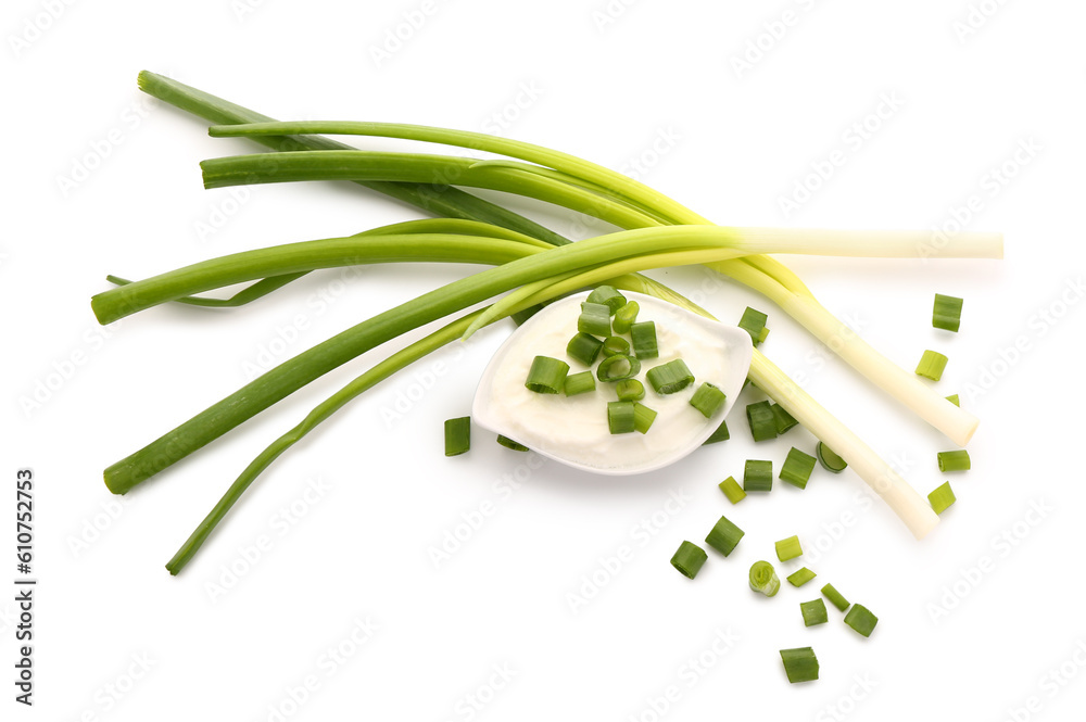 Gravy boat of tasty sour cream with sliced green onion on white background