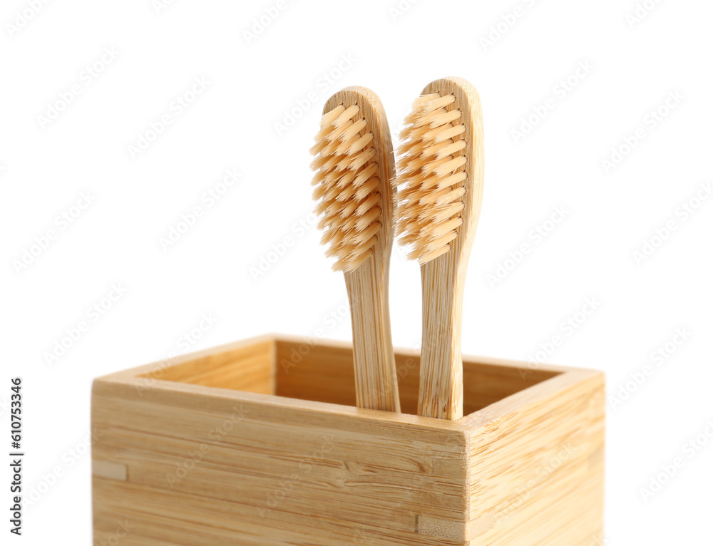 Bamboo tooth brushes in holder on white background, closeup