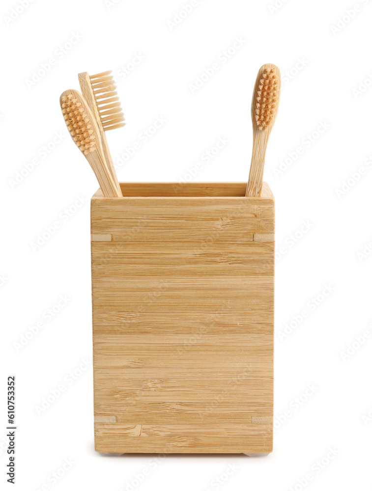 Bamboo tooth brushes in holder on white background