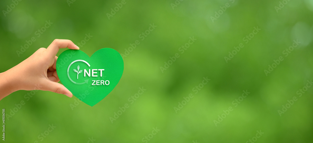 Girls hand holding green heart, text Net zero. Clean air beauty world concept.Esg