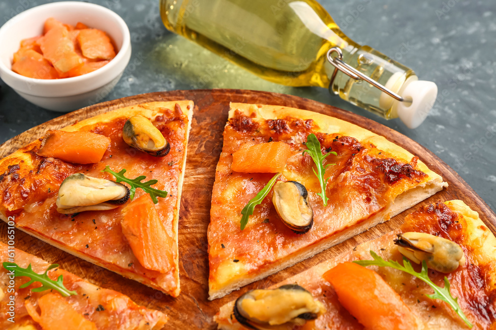 Plate of tasty seafood pizza on blue background, closeup