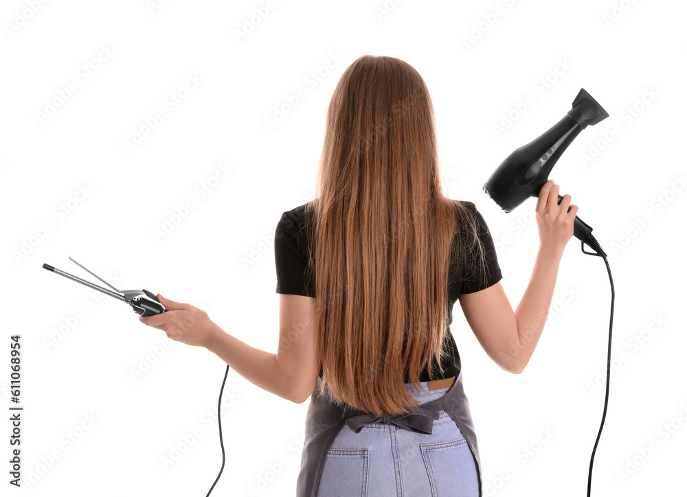 Female hairdresser with curling iron and dryer on white background, back view