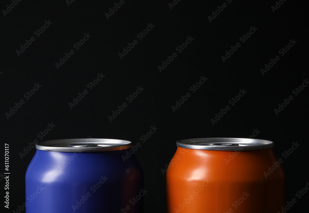 Cans of fresh soda on dark background, closeup