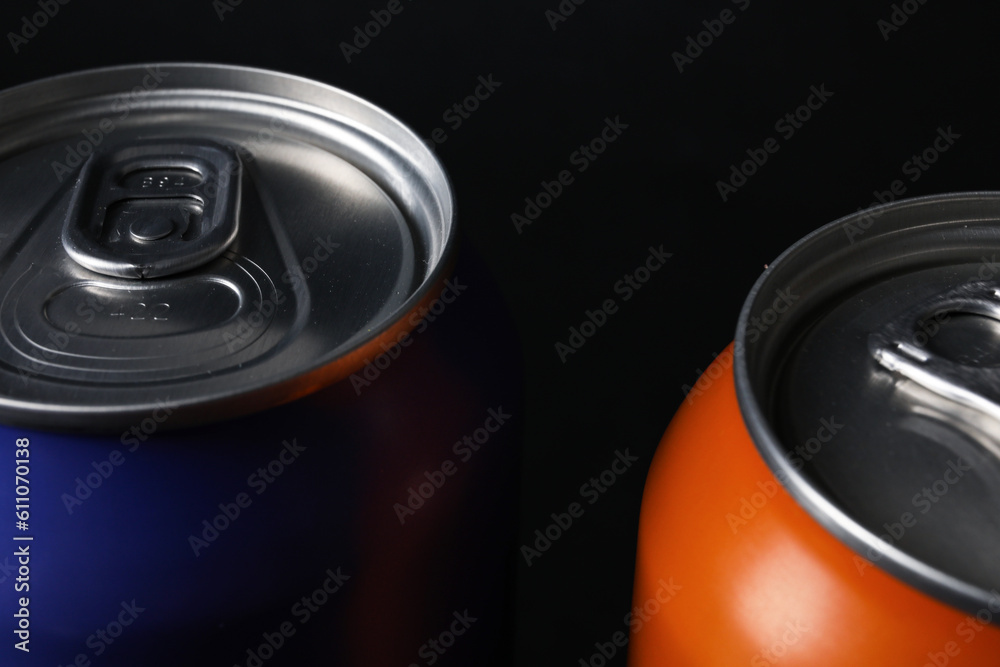 Cans of fresh soda on dark background, closeup