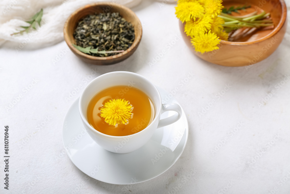 Cup of healthy dandelion tea on white background