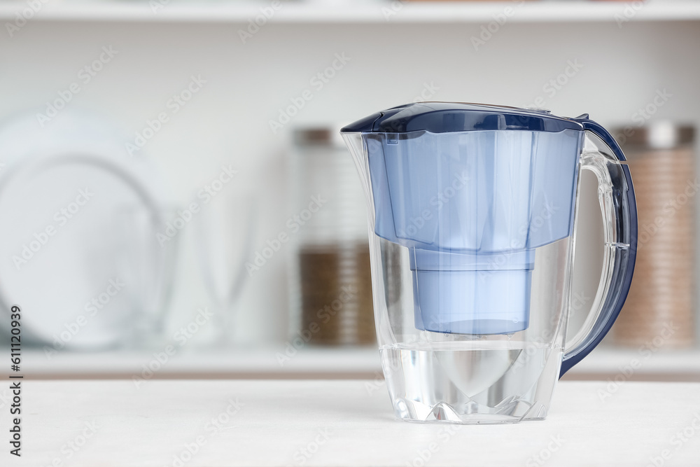 Water filter jug on table in kitchen