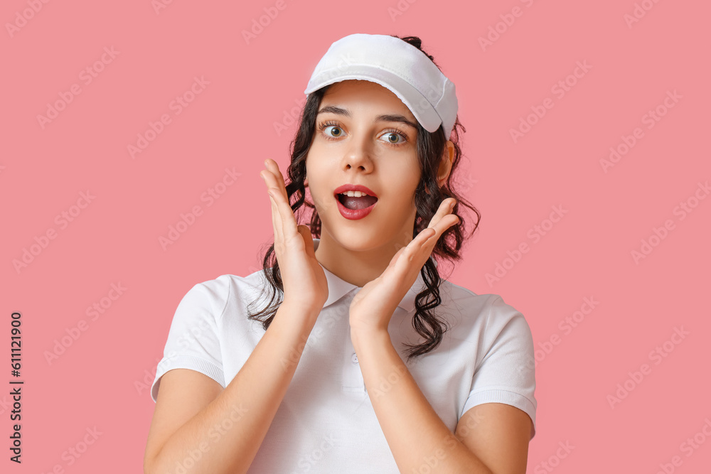 Surprised teenage tennis player on pink background, closeup