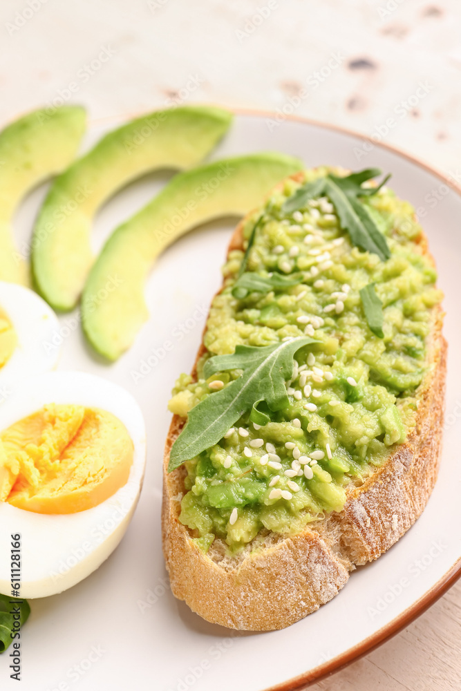 Plate of tasty bruschetta with avocado on table, closeup