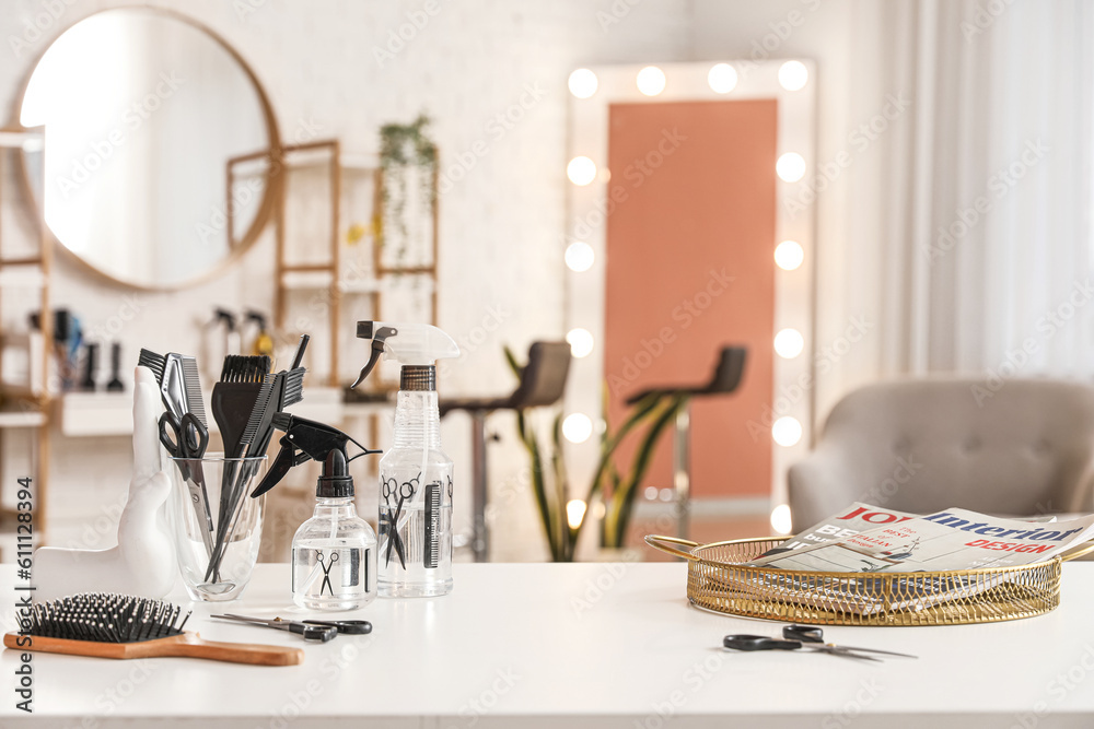 Different hairdressing tools on table in beauty salon