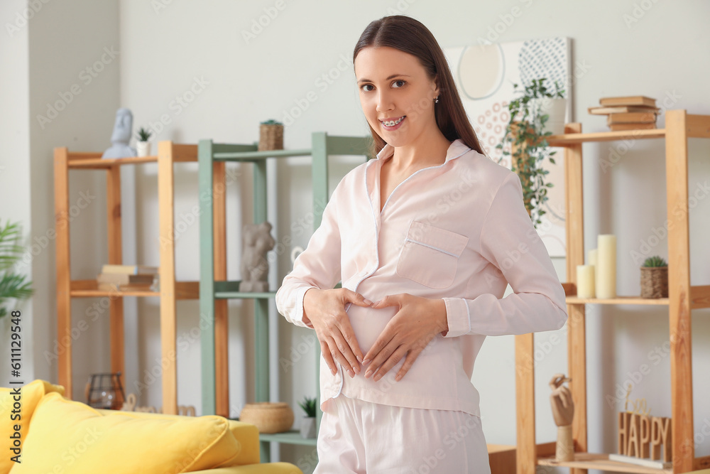 Young pregnant woman in pajamas at home