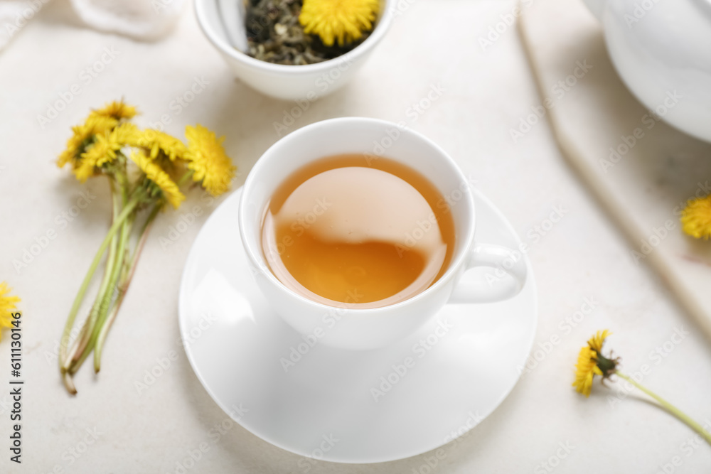 Cup of healthy dandelion tea on white background