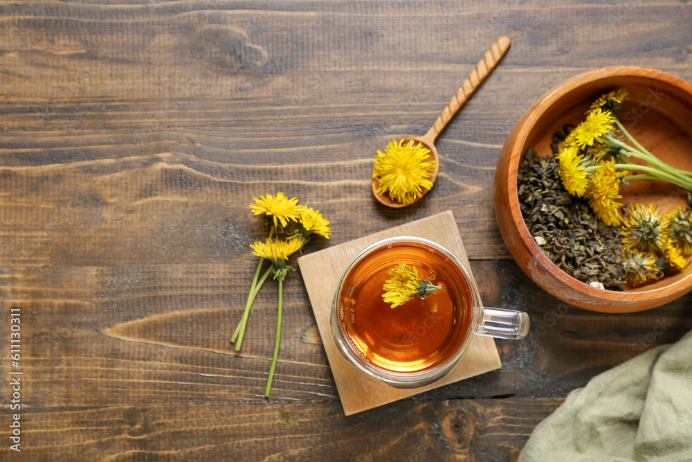 Bowl and glass cup of healthy dandelion tea on wooden background