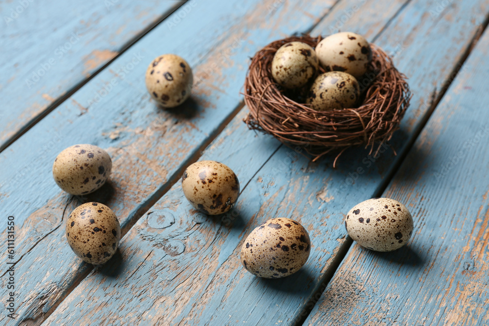 Fresh quail eggs on blue wooden background