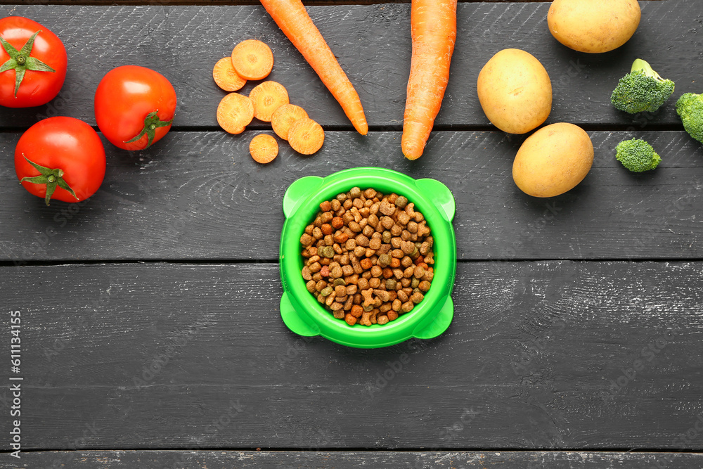 Composition with dry pet food and natural products on dark wooden background