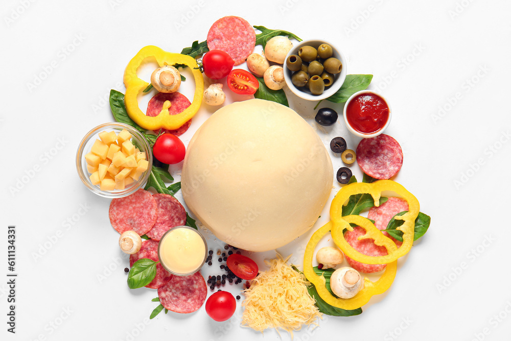 Raw dough and ingredients for preparing pizza on white background