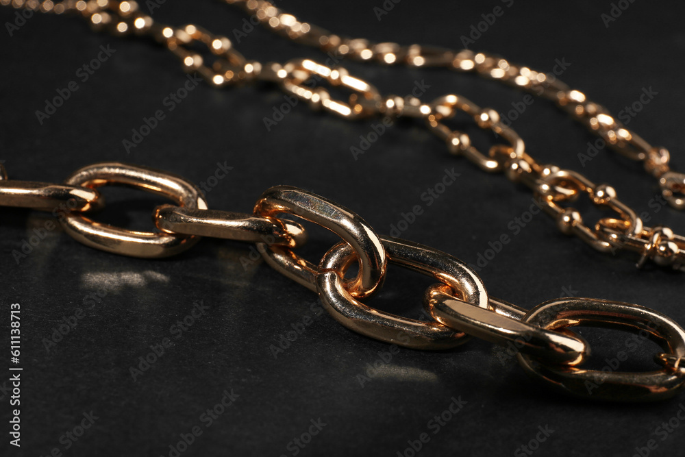 Beautiful chain bracelets on black background