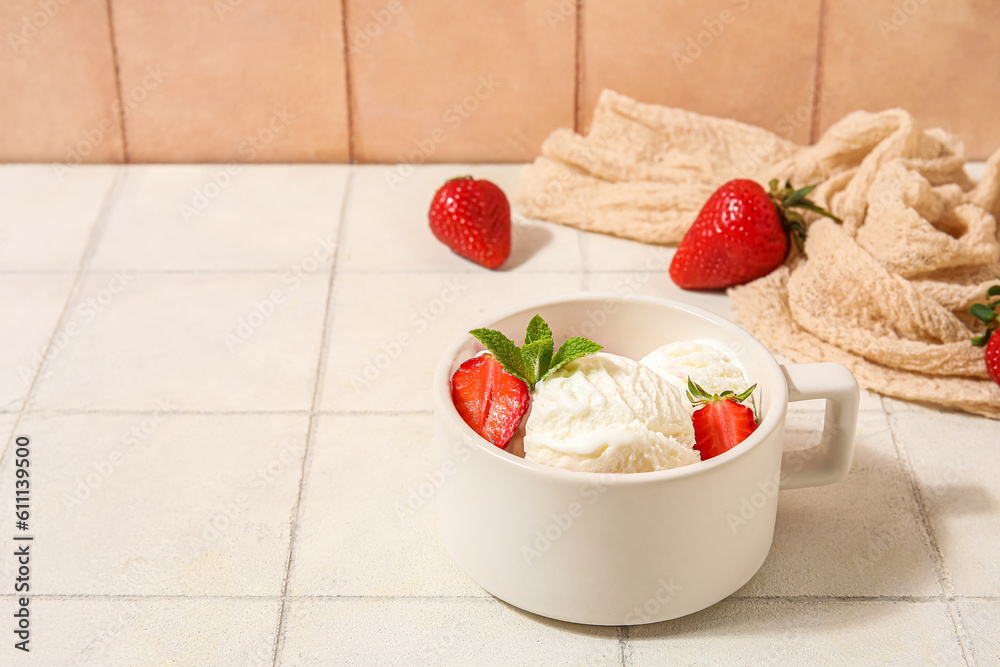 Bowl of strawberry ice cream on white tile table, closeup