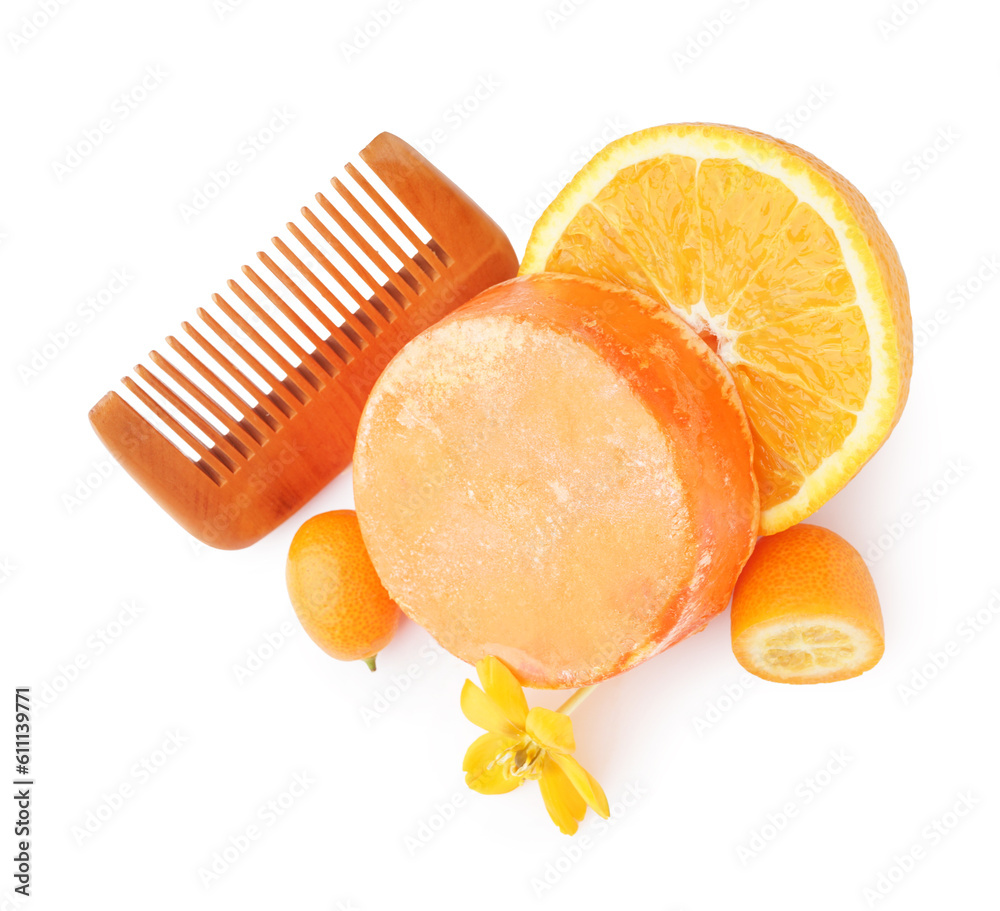 Solid shampoo bar with oranges, kumquat and comb on white background