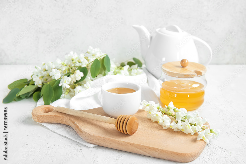 Composition with sweet honey and acacia flowers on light background