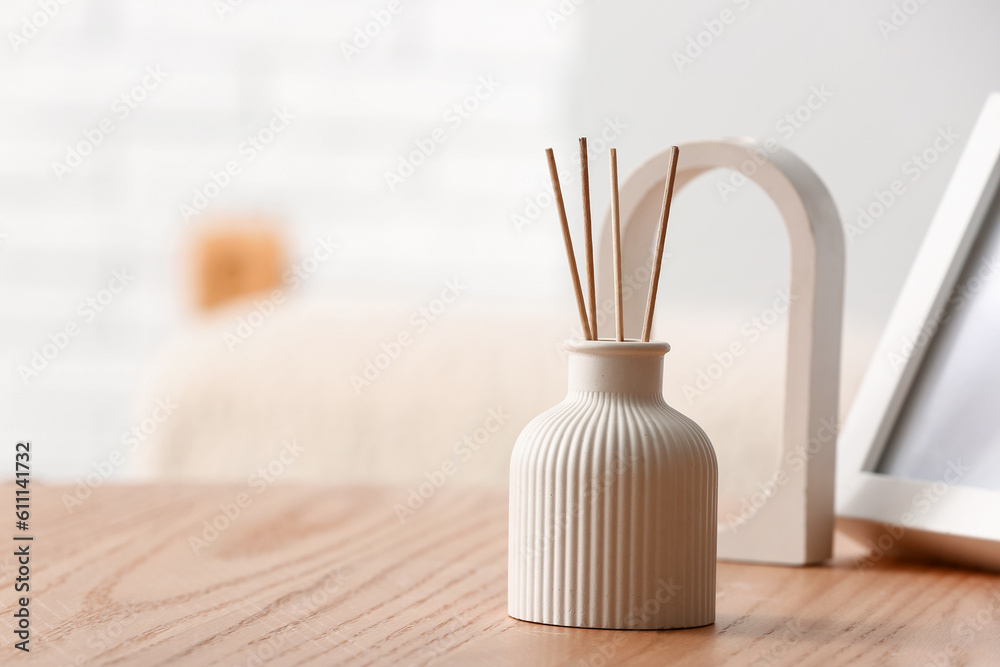 Bottle of reed diffuser on table in room, closeup