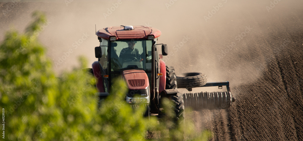 Tractor cultivating field with a cultivator selective focus