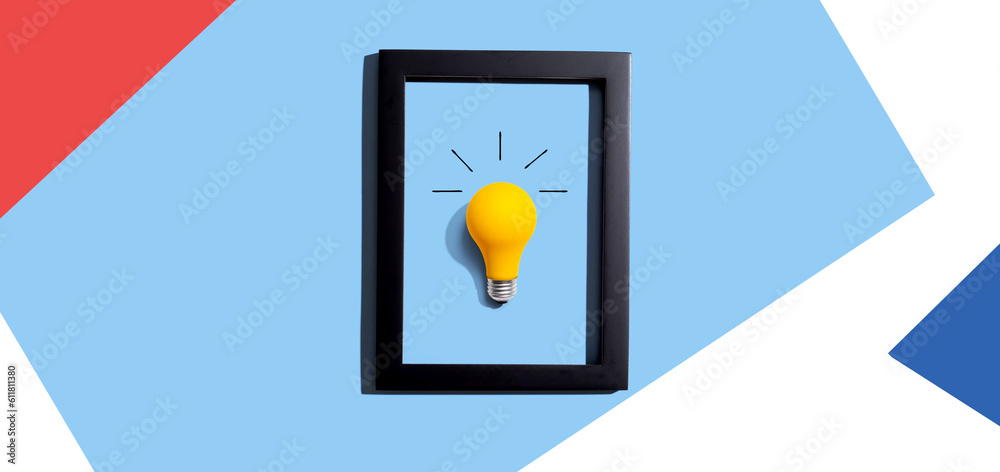 Yellow light bulb inside a frame - inspiration, creativity, energy, electricity themes