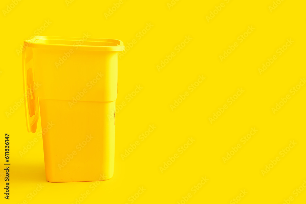 Container for garbage on yellow background. Recycling concept