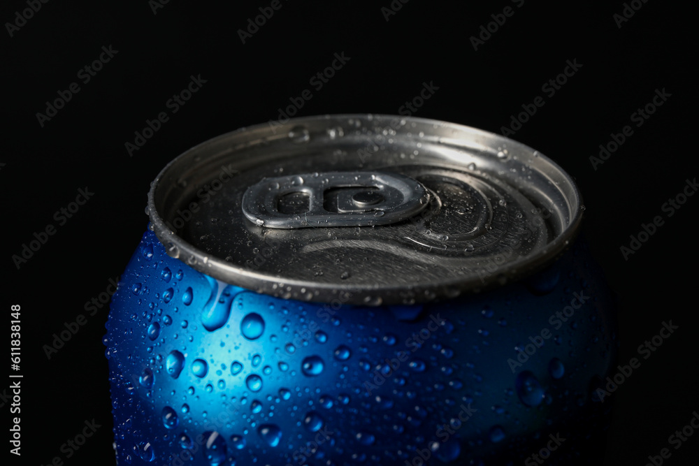 Blue can of fresh soda with water drops on dark background, closeup