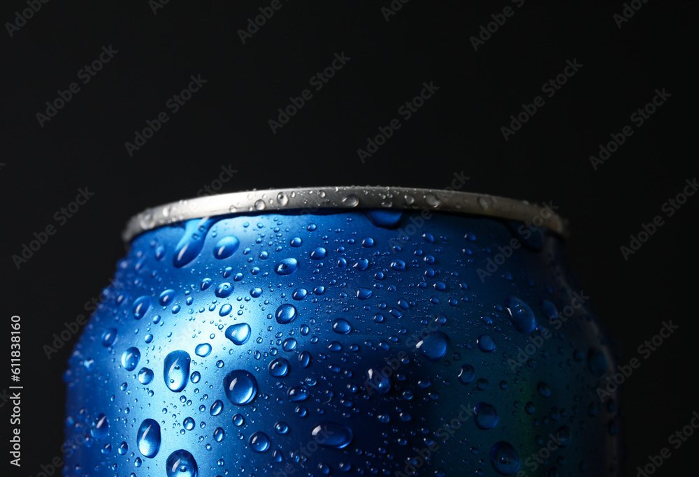 Blue can of fresh soda with water drops on dark background, closeup