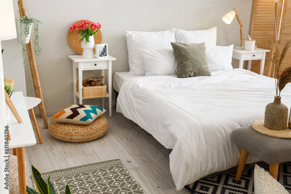 Interior of light bedroom with tables