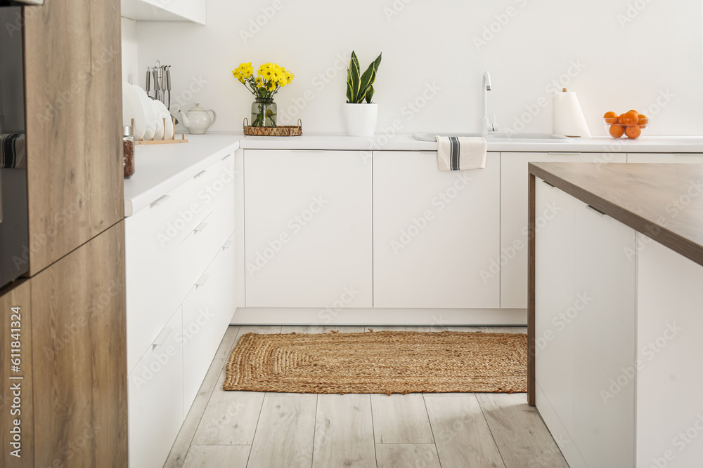 Wicker rug on floor in light kitchen