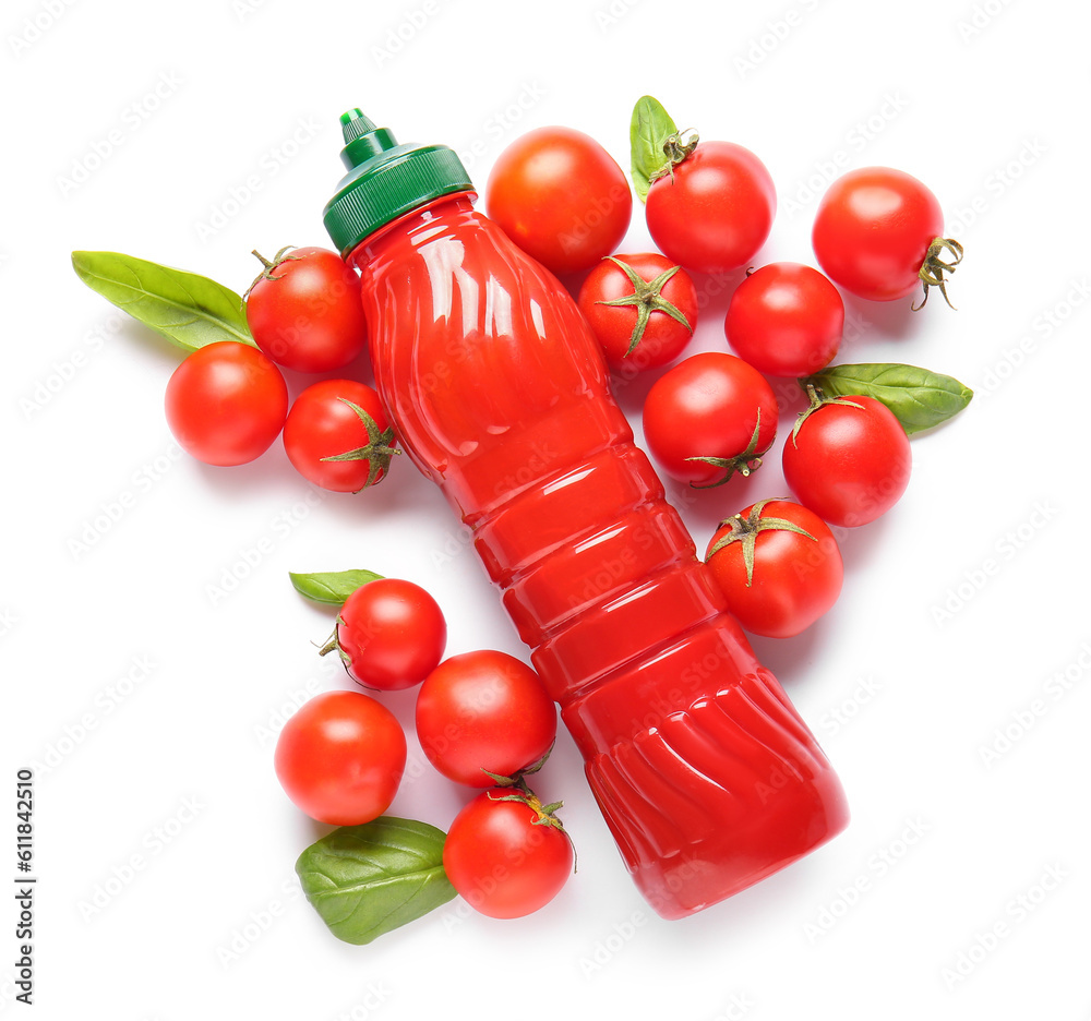 Bottle of ketchup and tomatoes on white background