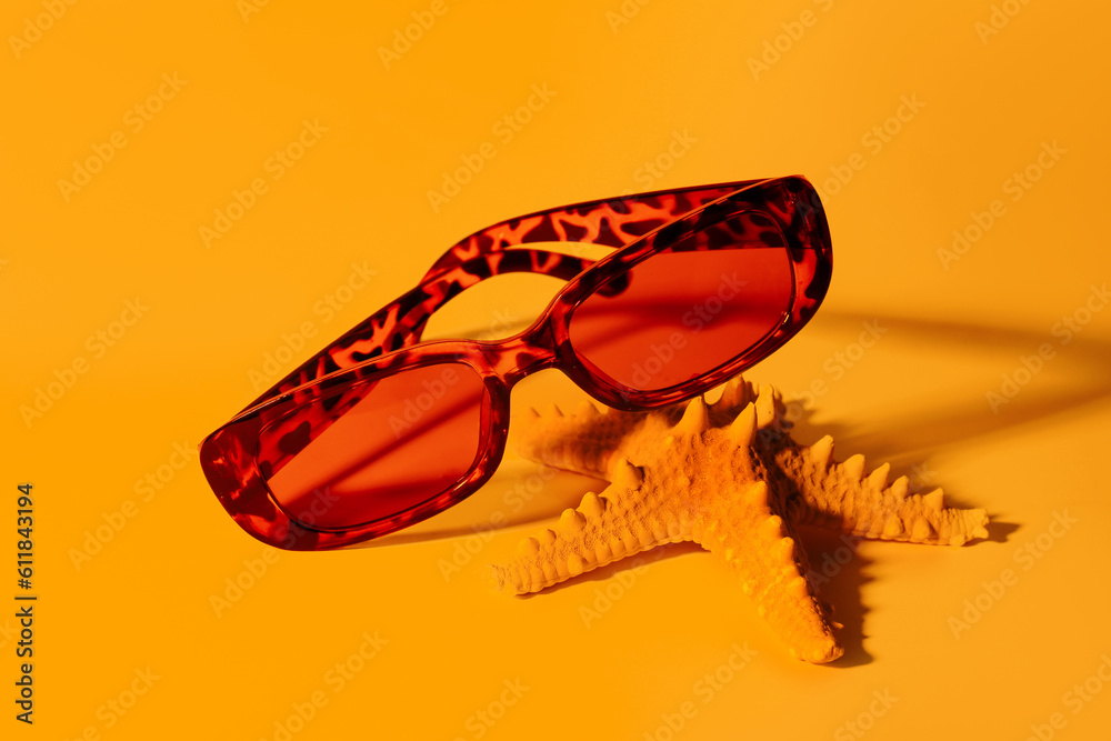 Leopard print sunglasses with starfish on orange background