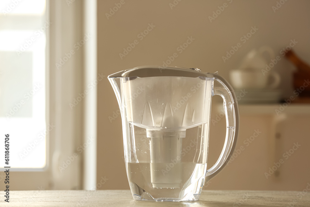 Water filter jug on table in kitchen