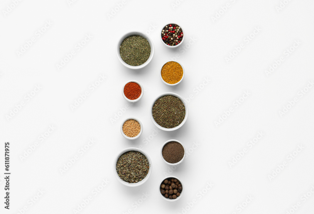 Composition with bowls of different aromatic spices on light background