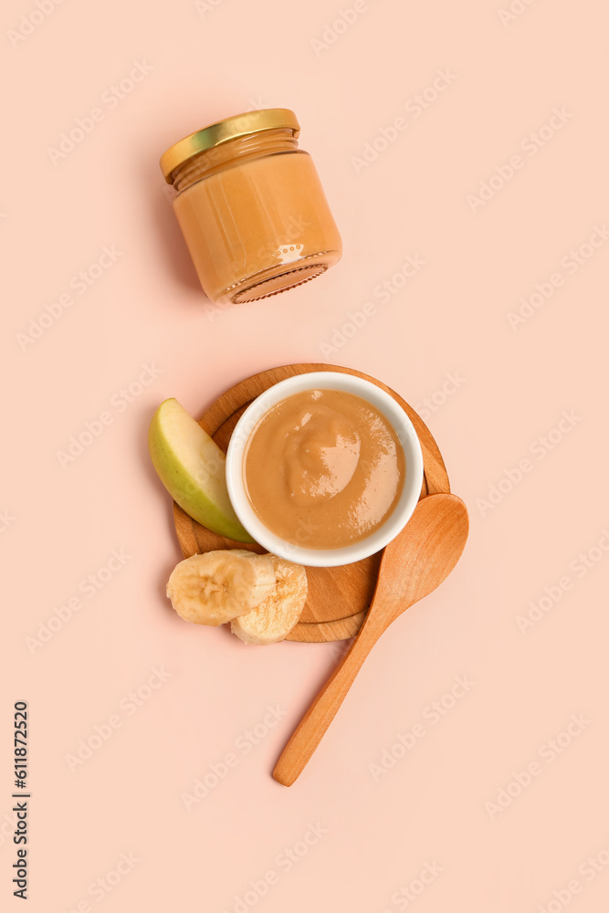 Bowl and jar with healthy baby food on color background