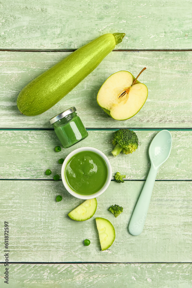 Composition with healthy baby puree and ingredients on color wooden background