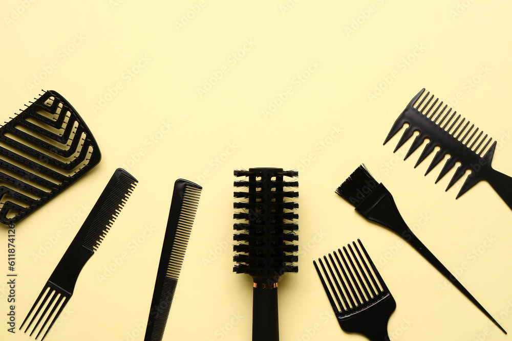 Hairdressers brushes on yellow background