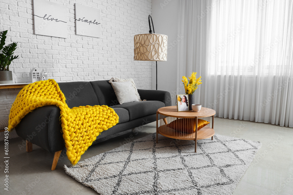 Interior of bright living room with cozy sofa and coffee table