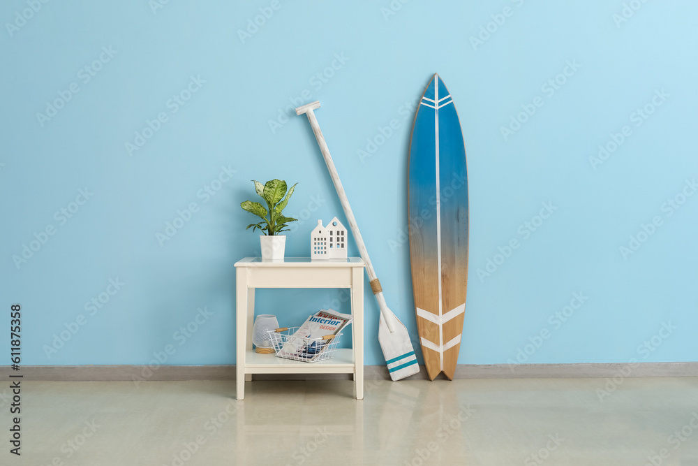 Interior of room with surfboard, paddle and table