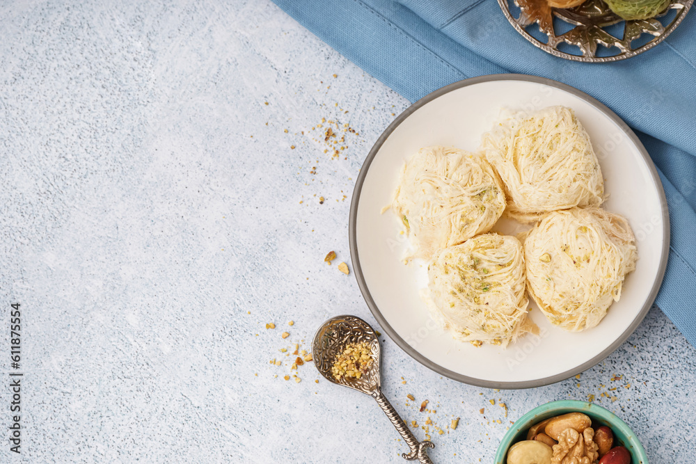 Plate with tasty Turkish Pismaniye on light background